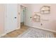 Bedroom featuring three doors and natural wood flooring at 209 Dickens Dr, Raleigh, NC 27610