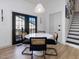Dining area with black-framed glass doors offering natural light and backyard views at 209 Dickens Dr, Raleigh, NC 27610