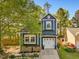 Charming two-story home with blue siding, white trim, flower boxes and a well-manicured front yard at 209 Dickens Dr, Raleigh, NC 27610