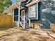 Charming home exterior with blue siding, white trim, and a inviting front porch, offering curb appeal at 209 Dickens Dr, Raleigh, NC 27610