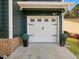 Well-maintained garage with decorative accents and a clean driveway, enhancing curb appeal at 209 Dickens Dr, Raleigh, NC 27610