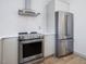 Modern kitchen featuring stainless steel appliances and sleek white tile backsplash at 209 Dickens Dr, Raleigh, NC 27610