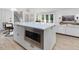 Modern kitchen island with a built-in microwave and adjacent living area at 209 Dickens Dr, Raleigh, NC 27610