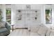 Cozy living room featuring stylish shelving, a comfortable sofa, and bright windows at 209 Dickens Dr, Raleigh, NC 27610