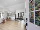 Open-concept living space with white walls, wood floors, and view to the kitchen with barstool seating at 209 Dickens Dr, Raleigh, NC 27610