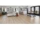 Bright, open living area with wood floors, white walls, lots of light and barstool seating at the kitchen at 209 Dickens Dr, Raleigh, NC 27610