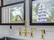 Elegant kitchen sink with a stylish gold faucet and view of the backyard at 209 Dickens Dr, Raleigh, NC 27610