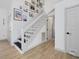Inviting entryway showcasing a modern staircase with stylish decor and wood flooring at 209 Dickens Dr, Raleigh, NC 27610