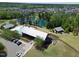Aerial view of community pool, clubhouse, and parking with pond in a planned neighborhood at 240 Liberty Star Rd, Wendell, NC 27591