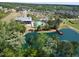 Aerial view of community amenities including a pool and pond surrounded by residential houses and trees at 240 Liberty Star Rd, Wendell, NC 27591