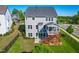 Aerial view of a spacious backyard with a wooden deck, screened porch, lush lawn, and fenced perimeter at 240 Liberty Star Rd, Wendell, NC 27591