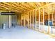 Expansive unfinished basement featuring exposed beams, framing, and concrete flooring, offering potential for customization at 240 Liberty Star Rd, Wendell, NC 27591