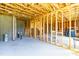 Unfinished basement with exposed wooden frames and concrete flooring offers potential for customization at 240 Liberty Star Rd, Wendell, NC 27591