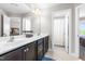 Well-lit bathroom with a double vanity, dark wood cabinets, and tiled floor at 240 Liberty Star Rd, Wendell, NC 27591