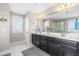 Elegant bathroom featuring dual sinks, dark cabinets, and a large mirror with ample counter space at 240 Liberty Star Rd, Wendell, NC 27591