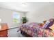 Comfortable bedroom featuring a large window with views and a colorful decorative bedspread at 240 Liberty Star Rd, Wendell, NC 27591