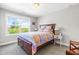 Comfortable bedroom featuring a queen sized bed, side tables, lamps, and bright sunlight at 240 Liberty Star Rd, Wendell, NC 27591