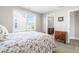 Cozy bedroom featuring a large window, neutral paint and carpet, plus a stylish cabinet for storage at 240 Liberty Star Rd, Wendell, NC 27591