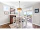 Bright dining area with modern table set, stylish light fixture, and sliding glass doors to deck at 240 Liberty Star Rd, Wendell, NC 27591