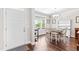 Bright dining room with hardwood floors, white trim, and a large window that looks out onto a covered porch at 240 Liberty Star Rd, Wendell, NC 27591