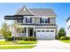 Charming two-story home with a manicured front yard, complemented by a two-car garage and inviting front porch at 240 Liberty Star Rd, Wendell, NC 27591