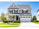 Charming two-story home with a well-manicured front yard, and two-car garage at 240 Liberty Star Rd, Wendell, NC 27591