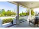 Inviting front porch with white railing and a cozy rocking chair, perfect for enjoying the neighborhood views at 240 Liberty Star Rd, Wendell, NC 27591