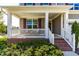 Charming front porch with white railing, brick steps, and decorative wreath on the front door at 240 Liberty Star Rd, Wendell, NC 27591