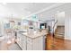 Open-concept kitchen featuring granite countertops, white cabinets, a large island, and seamless transition to living area at 240 Liberty Star Rd, Wendell, NC 27591