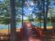 Scenic community lake with a wooden pier and fountain, offering a tranquil spot for relaxation and enjoyment at 240 Liberty Star Rd, Wendell, NC 27591