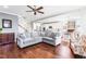 Bright living room with hardwood floors, plush sofa, and an open concept to the kitchen at 240 Liberty Star Rd, Wendell, NC 27591