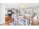 Open concept living space with hardwood floors, dining area, living room, and modern staircase at 240 Liberty Star Rd, Wendell, NC 27591