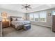 Spacious main bedroom featuring a tray ceiling, many windows, and neutral color palette at 240 Liberty Star Rd, Wendell, NC 27591