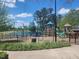 Community playground is fenced and has various structures for the to enjoy; view of lake in background at 240 Liberty Star Rd, Wendell, NC 27591