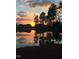 Picturesque pond at sunset reflecting trees and neighborhood homes to create an oasis within the community at 240 Liberty Star Rd, Wendell, NC 27591