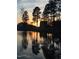 Sunset reflecting on the tranquil pond with silhouette of trees at 240 Liberty Star Rd, Wendell, NC 27591
