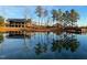 Scenic view of community buildings reflecting on a tranquil pond surrounded by trees and greenery at 240 Liberty Star Rd, Wendell, NC 27591