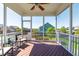 Relaxing screened-in porch with comfortable seating and a view of the landscaped backyard at 240 Liberty Star Rd, Wendell, NC 27591