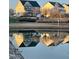 Homes reflected in a calm pond, showcasing the beautiful neighborhood scenery at 240 Liberty Star Rd, Wendell, NC 27591