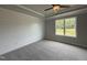 Inviting bedroom featuring a tray ceiling and a large window with backyard views at 244 Bluejay St, Clayton, NC 27520