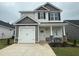 Charming two-story home featuring a single-car garage and classic architectural details, enhanced by a manicured front yard at 244 Bluejay St, Clayton, NC 27520