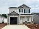 Charming new construction home with two stories, a two car garage, and stone accents on the columns at 244 Bluejay St, Clayton, NC 27520