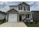 Charming two-story home featuring a two-car garage and inviting front porch at 244 Bluejay St, Clayton, NC 27520
