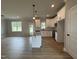 Bright kitchen boasts stainless appliances, granite countertops and an island at 244 Bluejay St, Clayton, NC 27520