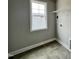 Small laundry room with tile flooring, neutral paint, and a wire shelf at 244 Bluejay St, Clayton, NC 27520