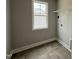 Efficient laundry room with tile flooring, window, and wire shelving for organized storage at 244 Bluejay St, Clayton, NC 27520