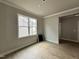 Cozy living room with hard wood floors, neutral paint, crown molding, and a large window at 244 Bluejay St, Clayton, NC 27520