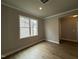 Neutral-toned room with hardwood floors illuminated by natural light at 244 Bluejay St, Clayton, NC 27520
