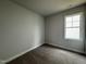 Cozy bedroom with a large window, carpet, and neutral paint at 250 Bluejay St, Clayton, NC 27520