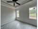 Well-lit bedroom with large windows, tray ceiling, and new carpet at 250 Bluejay St, Clayton, NC 27520